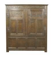 Lot 325 - A carved oak hanging cupboard