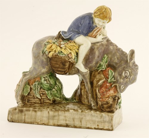 Lot 83 - A figure of a donkey eating carrots