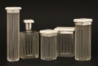 Lot 246 - Four Art Deco ivory-topped and silver-collared dressing table pots
