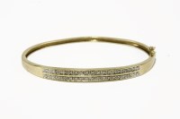 Lot 226 - A gold two row diamond set bangle