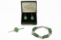 Lot 207 - A white gold oval carved jade plaque bar brooch