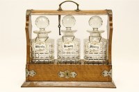 Lot 516 - An oak and three bottle tantalus