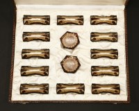 Lot 233 - A set of twelve enamel knife rests