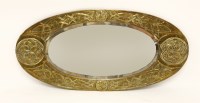 Lot 65 - An Arts & Crafts embossed oval brass mirror