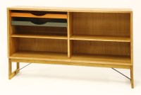 Lot 657 - A light oak cabinet