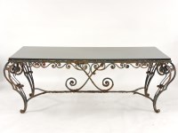Lot 547 - A wrought iron garden table