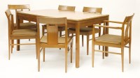Lot 318 - A teak dining suite