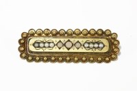 Lot 31 - A Victorian gold brooch set with three coral cabochons