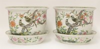 Lot 107 - A pair of famille rose planters and stands