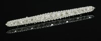 Lot 130 - An Art Deco graduated diamond bar brooch