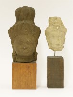 Lot 553 - Two stone carvings of heads of a bodhisattva