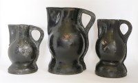 Lot 103 - A matched set of three graduated 'Black Jack' leather jugs