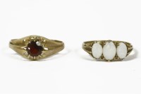 Lot 1046 - A 9ct gold three stone oval cut opal cabochon ring