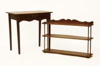 Lot 1723 - An early 19th century mahogany three tiered shelf with brass columns