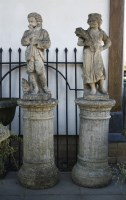 Lot 900 - A pair of reconstituted stone figures of children