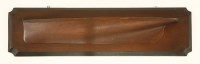 Lot 129 - A carved pine half hull model of a sailing boat