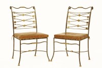 Lot 886 - A pair of Italianate wrought iron and gilt highlighted side chairs