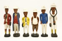 Lot 535 - A collection of six Nigerian carved and hand painted wooden colonial figures