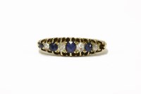 Lot 10 - An Edwardian 18ct gold nine stone sapphire and diamond boat-shaped ring