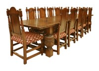 Lot 552 - An oak refectory table and twelve chairs