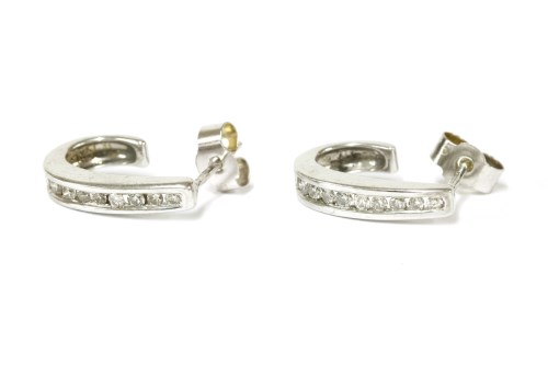 Lot 21 - A pair of 9ct white gold diamond set tapered hoop stud earrings