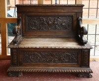 Lot 532 - An oak box seat hall settle