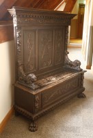 Lot 536 - A stained oak high-backed box seat hall settle