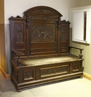 Lot 542 - A stained oak box seat hall settee