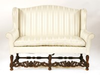 Lot 653 - A Carolean-style walnut wing backed two-seat settee