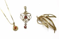 Lot 24 - An Edwardian gold oval cut ruby doublet open work pendant