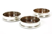 Lot 138 - A set of three 20th century silver wine coasters