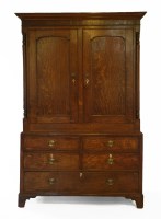 Lot 510 - A George III oak linen press