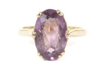 Lot 19 - A gold single stone oval cut amethyst ring