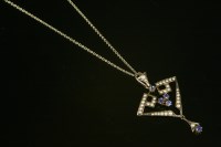 Lot 669 - An Edwardian pendant gold sapphire and split pearl openwork pendant