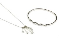 Lot 90 - A 9ct white gold cubic zirconia hinge bangle