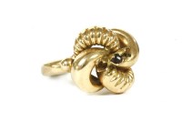 Lot 116 - A Continental gold plain polished and textured knot ring set with three garnets
