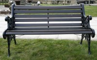 Lot 1041 - A garden seat with slatted wooden back and seat