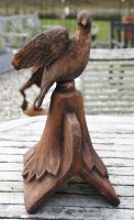 Lot 1072 - A terracotta dove roof tile ridge finial depicting a dove looking forwards