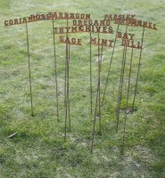Lot 1087 - A set of twelve wrought iron garden herb names/markers