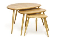 Lot 615 - An Ercol elm pebble design nest of three tables