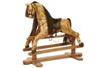 Lot 589 - A laminate rocking horse