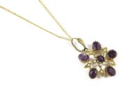 Lot 63 - An Edwardian gold amethyst and split pearl openwork pendant