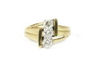 Lot 39 - An 18ct gold three stone portrait brilliant cut diamond ring