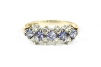 Lot 68 - A 9ct gold modified princess cut tanzanite and diamond half hoop ring