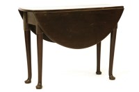 Lot 932 - A walnut pad foot table