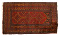 Lot 1033 - A small red ground carpet