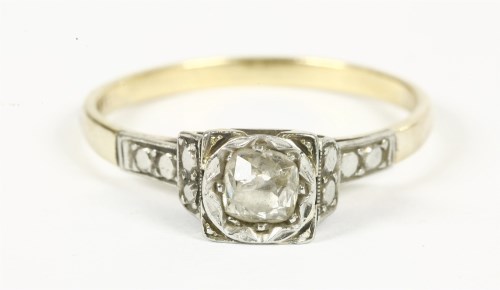 Lot 11 - A gold single stone illusion set cushion cut diamond ring