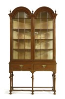 Lot 1063 - A walnut display cabinet