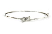 Lot 222 - A 9ct white gold diamond cross over hinged bangle