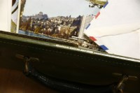Lot 292 - Two green leather travelling cases